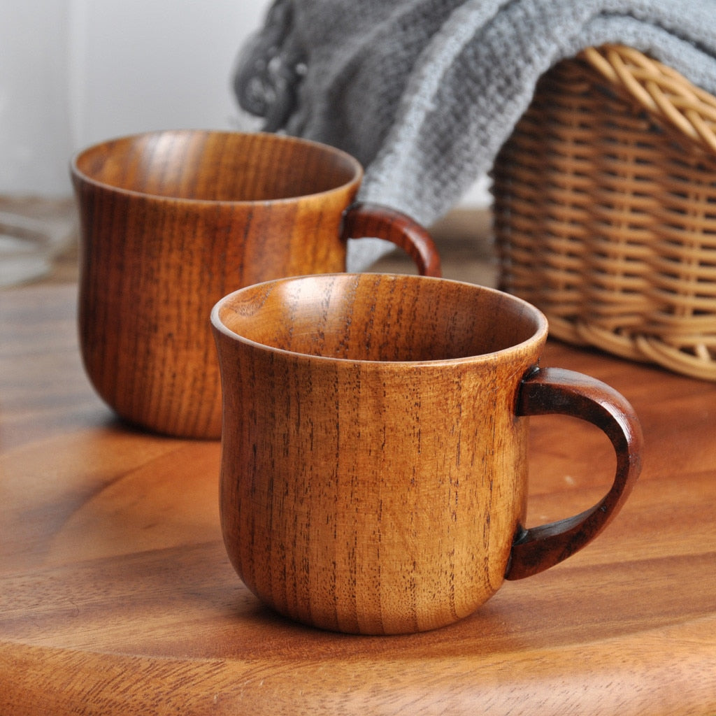 two wood mugs sitting next to each other one in front of the other